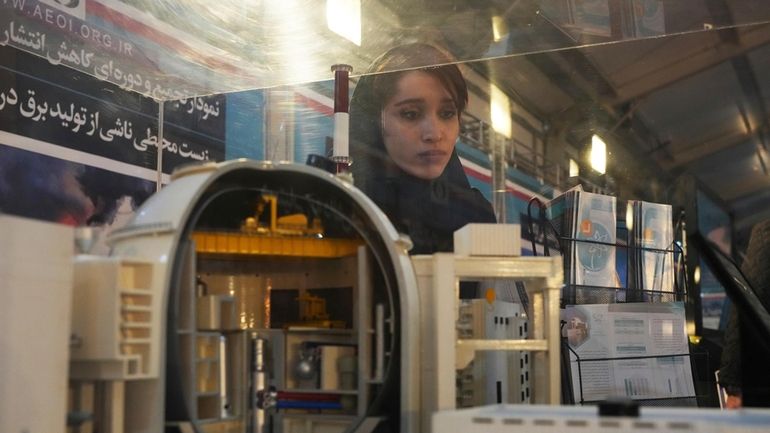 A student looks at a model of Bushehr nuclear power...