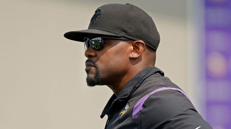 Minnesota Vikings defensive coordinator Brian Flores watches as his team...