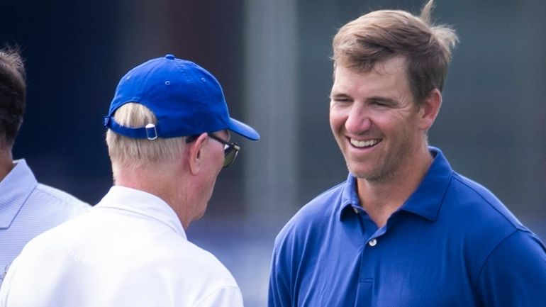 Retired New York Giants quarterback Eli Manning talks with Giants...