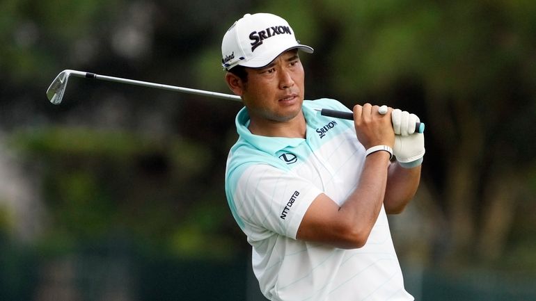 Hideki Matsuyama, of Japan, watches his shot from the 17th...