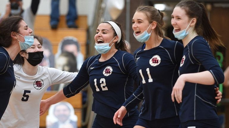 Sally Tietjen #12 of Smithtown West, center, and teammates, from...