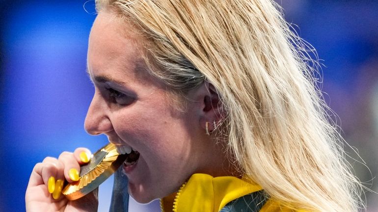 Gold medalist, Ariarne Titmus, of Australia, poses for the media...