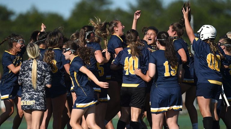 West Babylon teammates celebrate after their overtime victory over host...