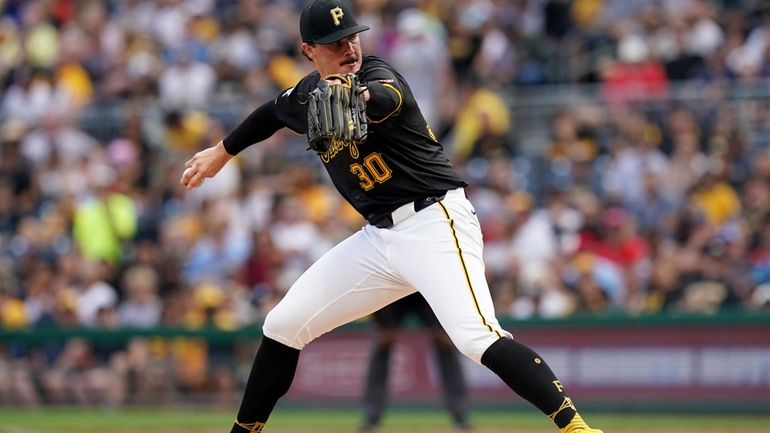 Pittsburgh Pirates starting pitcher Paul Skenes delivers during the first...