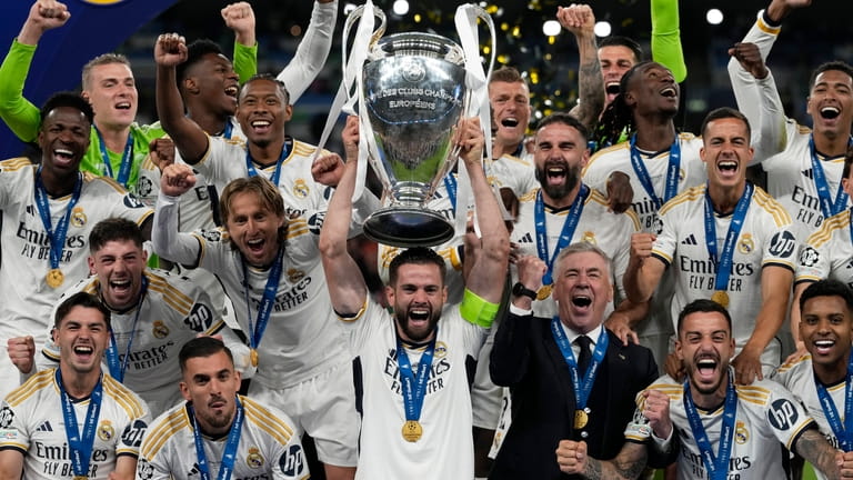 Real Madrid's team captain Nacho lifts the trophy after winning...