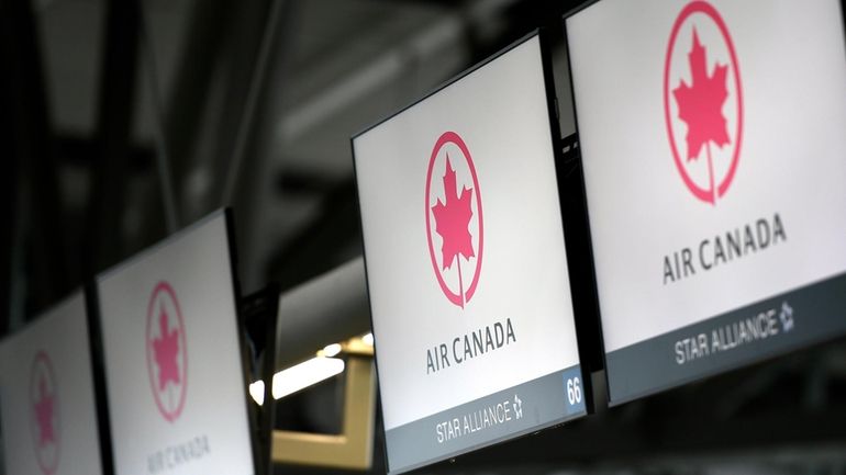 Air Canada check-in screens are seen at the Ottawa International...