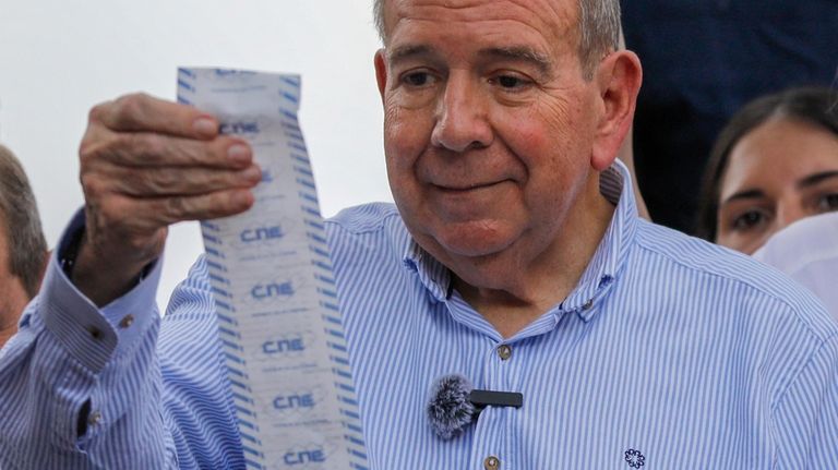 Opposition candidate Edmundo Gonzalez holds up vote tally sheets from...