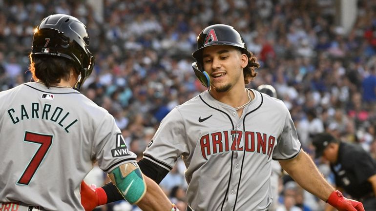 Arizona Diamondbacks outfielder Alek Thomas, right, celebrates with Corbin Carroll...