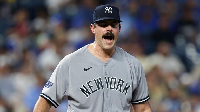 Yankees pitcher Carlos Rodon reacts after the Royals scored a...