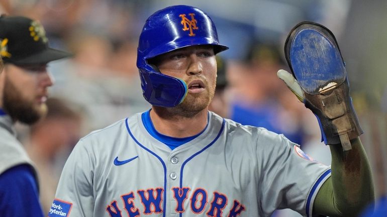 Mets' Brandon Nimmo is congratulated by teammates after he scored...