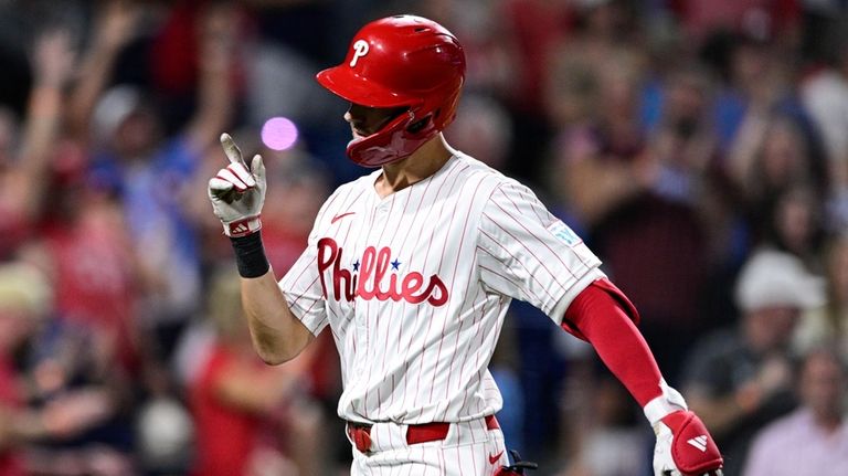 Philadelphia Phillies' Trea Turner reacts after hitting a solo home...