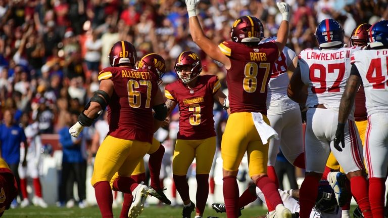 Washington Commanders place kicker Austin Seibert (3) celebrates with teammate...