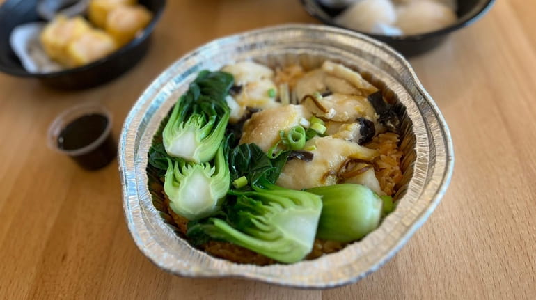 Claypot rice with fish and bok choy served takeout style at...
