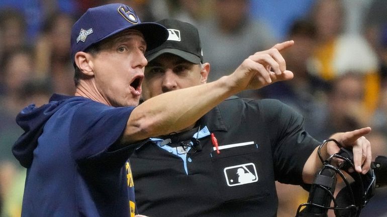 Milwaukee Brewers manager Craig Counsell argues with home plate umpire...