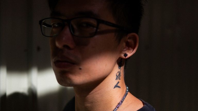 The words Hongkonger can be seen tattooed to the neck...