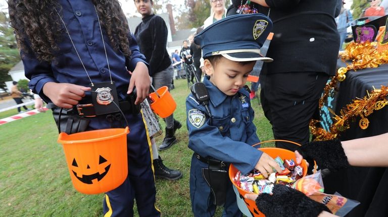 Walter Lynch, of Stony Brook, dressed as a police officer,...