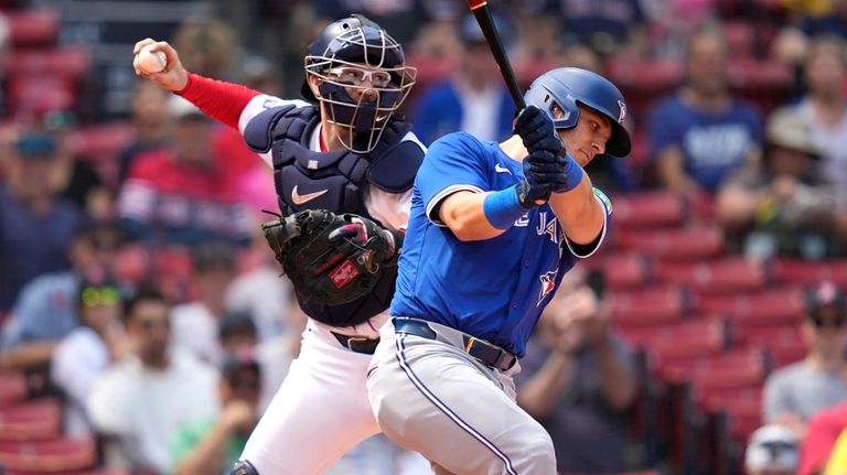 Boston Red Sox catcher Danny Jansen, left, tries to throw...