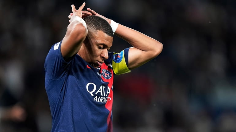 PSG's Kylian Mbappe reacts after missing a scoring chance during...