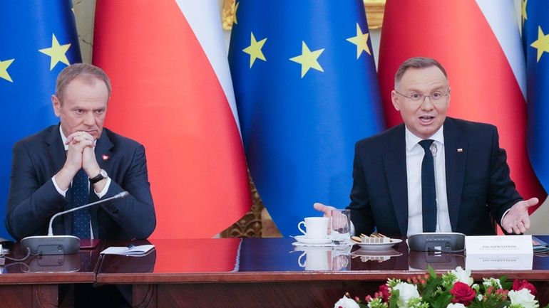 Poland's Prime Minister Donald Tusk, left, and President Andrzej Duda...