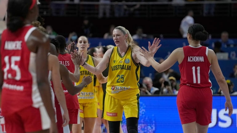 Australia's Lauren Jackson, second right, shakes hands with Canadian players...