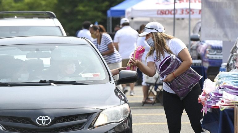 School supplies, including backpacks and personal protective equipment, are given...