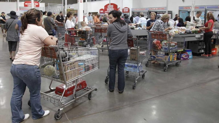 Shoppers wait at the check-out line at Costco Wholesale in...