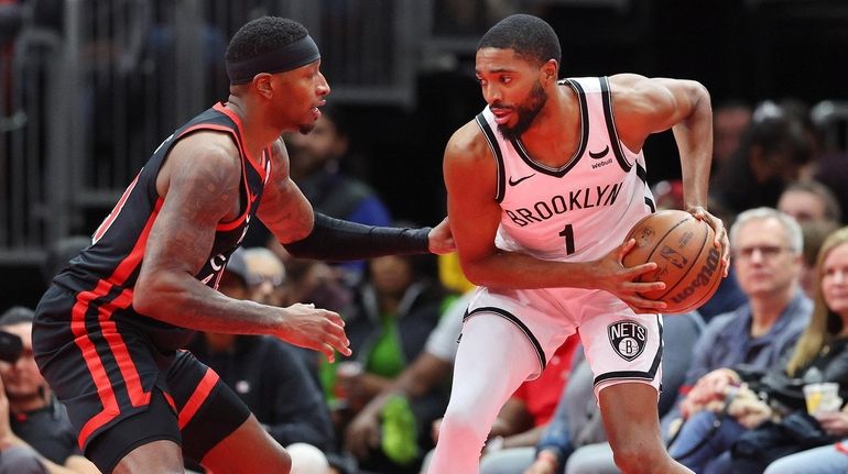 Mikal Bridges #1 of the Nets is defended by Torrey...