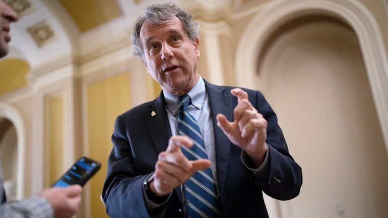 Senate Banking Committee Chairman Sherrod Brown, D-Ohio, speaks with reporters...