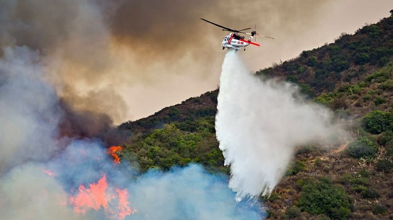 Firefighters battle the Airport Fire along Trabuco Creek Road in...