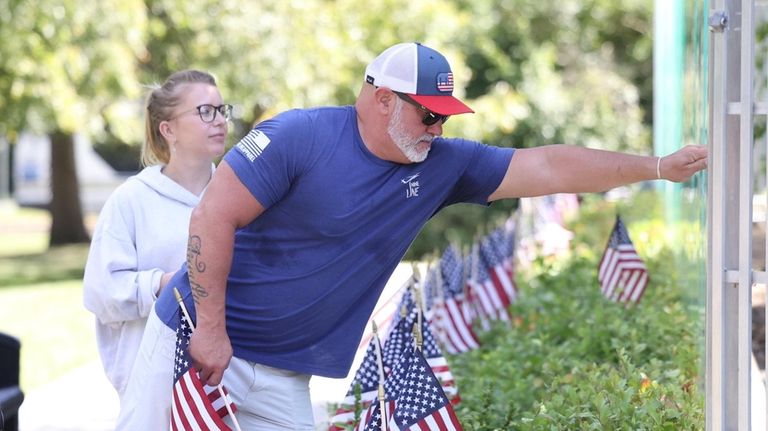 Retired NYPD Det. David Velez, of Amityville,with his wife Agnes,...