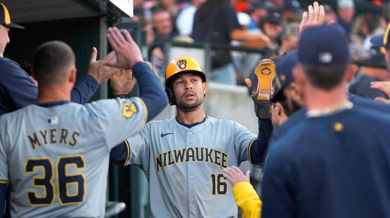 Milwaukee Brewers' Blake Perkins (16) celebrates after scoring against the...