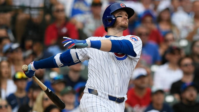 Chicago Cubs' Ian Happ watches his three-run home run during...