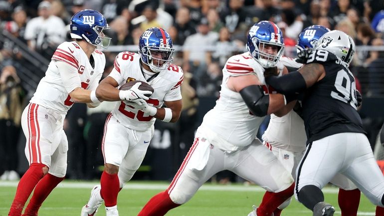 Saquon Barkley of the Giants runs the ball in the first quarter...