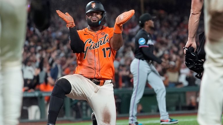 San Francisco Giants' Heliot Ramos (17) reacts after scoring on...