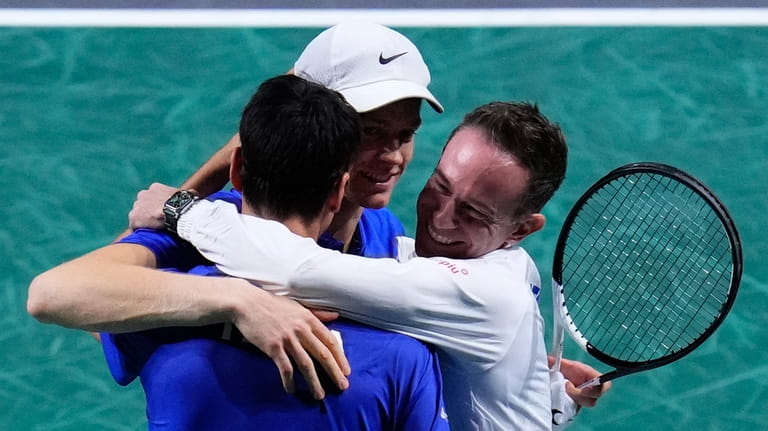 Captain of Team Italy Filippo Volandri, right, hugs Italy's Janik...