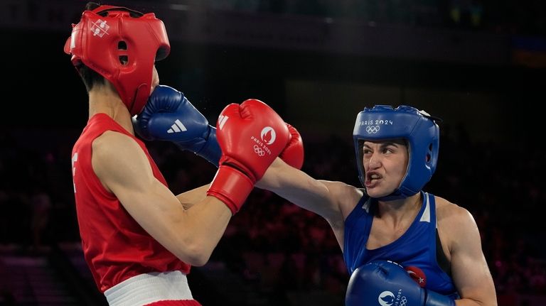 Taiwan's Lin Yu-ting, left, fights Turkey's Esra Yildiz in their...