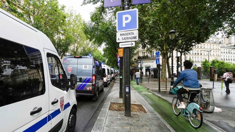 Police vehicles line up near the Gare de L'Est at...