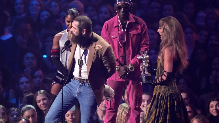 Post Malone, left, and Taylor Swift accept the award for...