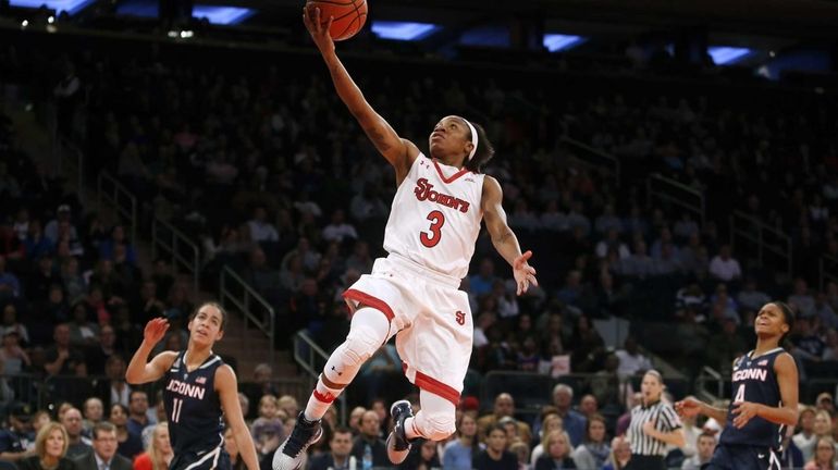 St. John's Aliyyah Handford (3) scores on a fast break...