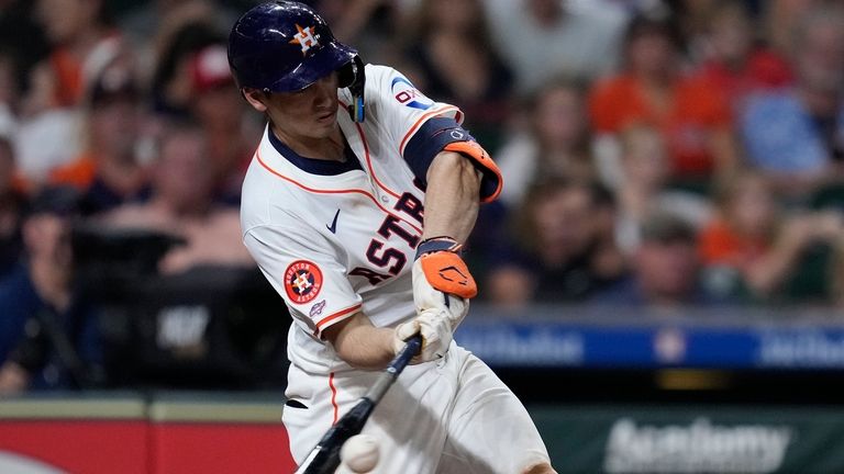 Houston Astros' Shay Whitcomb knocks a base hit during the...