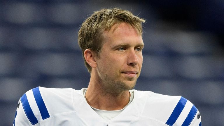 Indianapolis Colts quarterback Nick Foles (9) walks on the field...