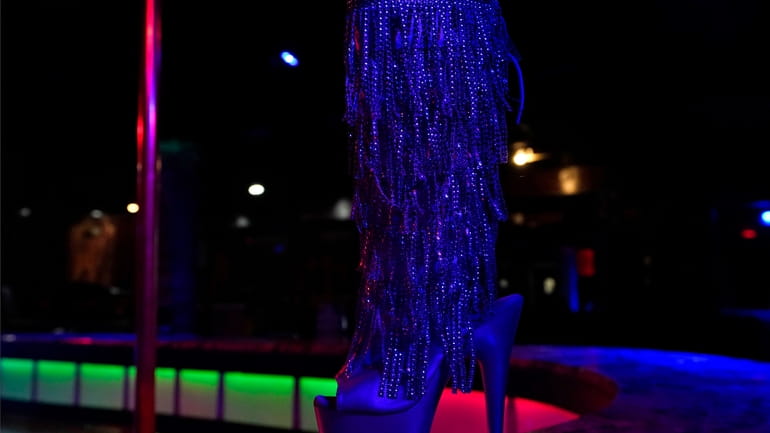 An exotic dancer's shoe on stage at Scores Gentlemen's Club,...