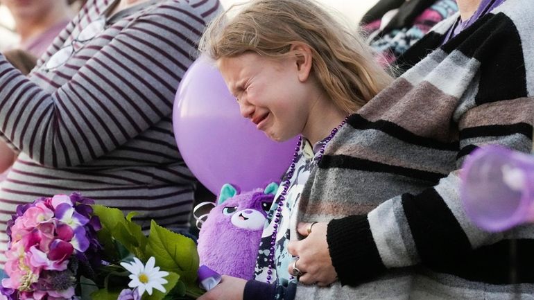 Kristlyn Wood, a cousin of 11-year-old Audrii Cunningham, reacts during...