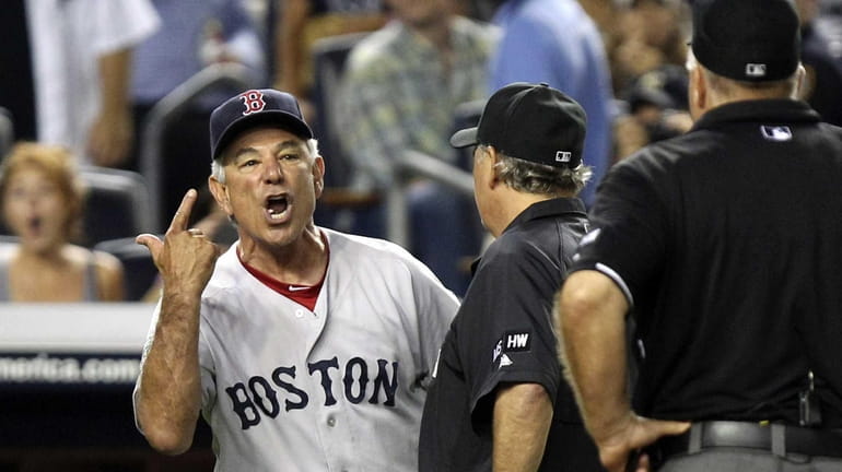 Boston Red Sox manager Bobby Valentine, left, argues with umpire...