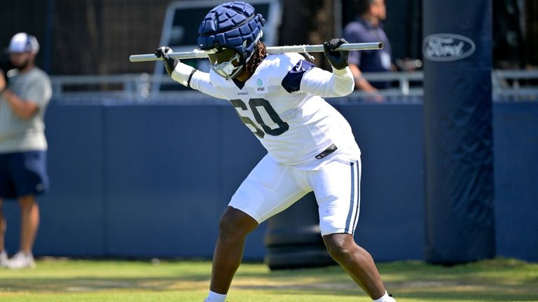 Dallas Cowboys offensive tackle Tyler Guyton participates in drills during...