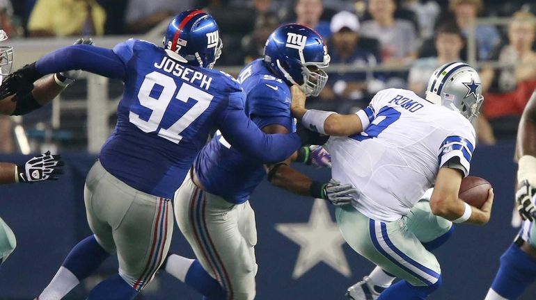 Dallas Cowboys quarterback Tony Romo (9) is sacked by New...