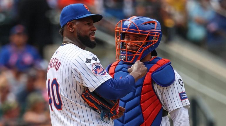 Mets pitcher Luis Severino talks on the mound with catcher...