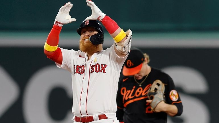 Boston Red Sox's Justin Turner celebrates his RBI double during...