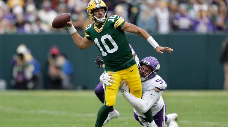 Green Bay Packers quarterback Jordan Love (10) passes the football...