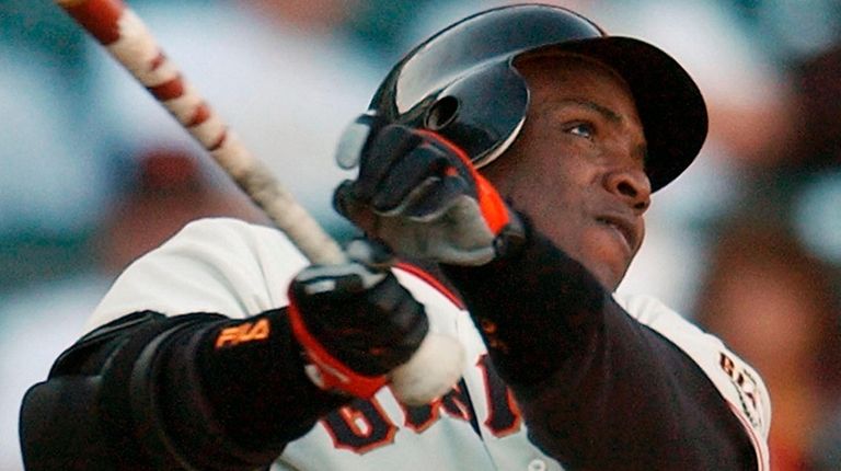 The Giants' Barry Bonds watches a solo home run against...